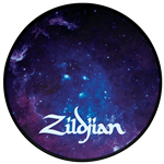 A six-inch circular Zildjian Galaxy practice pad showing a colorful outer-space design on a silicone surface with an integrated black base.