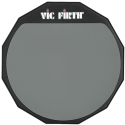 A six-inch circular Vic Firth single-sided drum practice pad with a soft gray gum rubber surface, wooden base, and printed black brand logo.